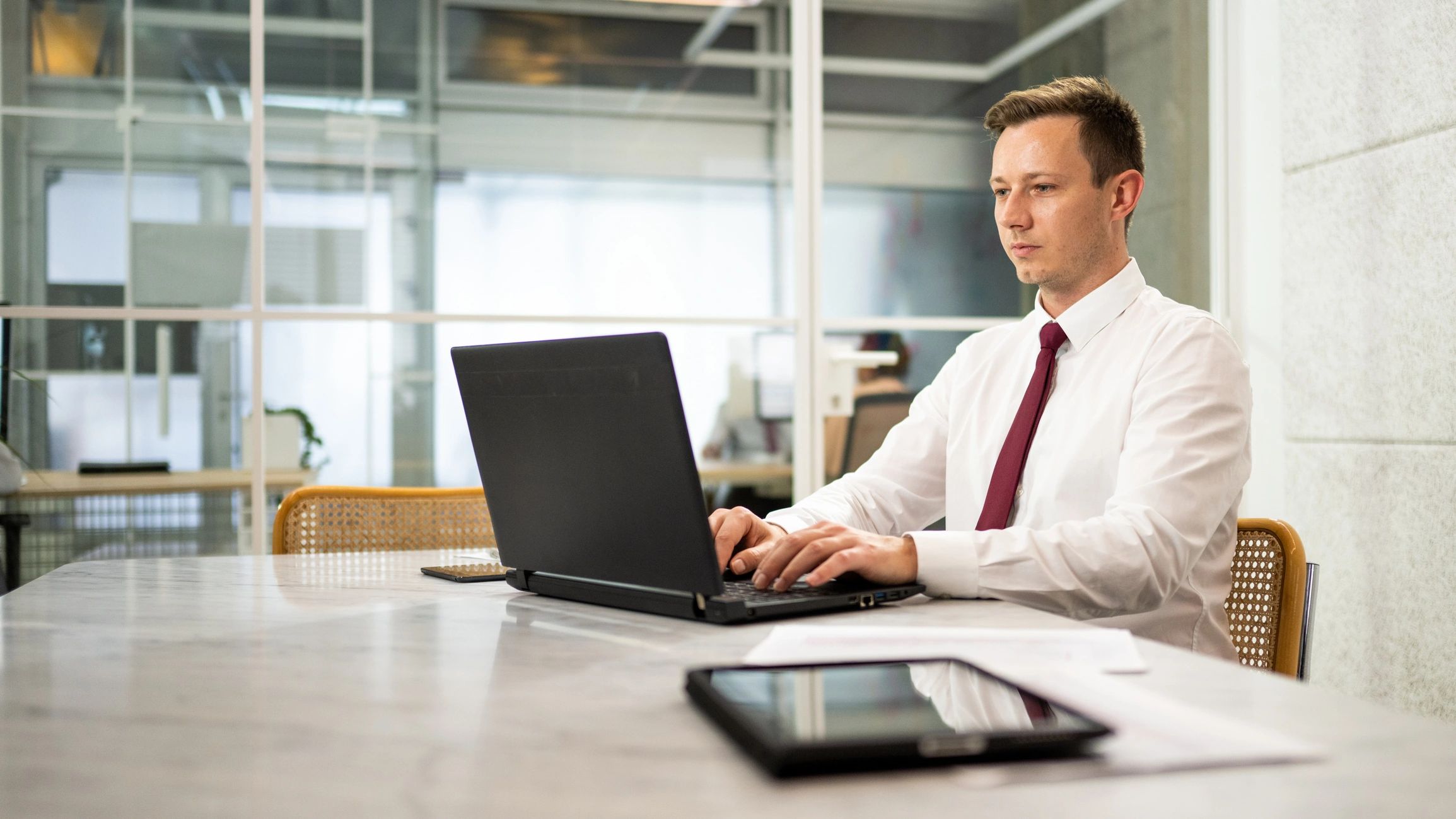 Professional client representative working on a laptop