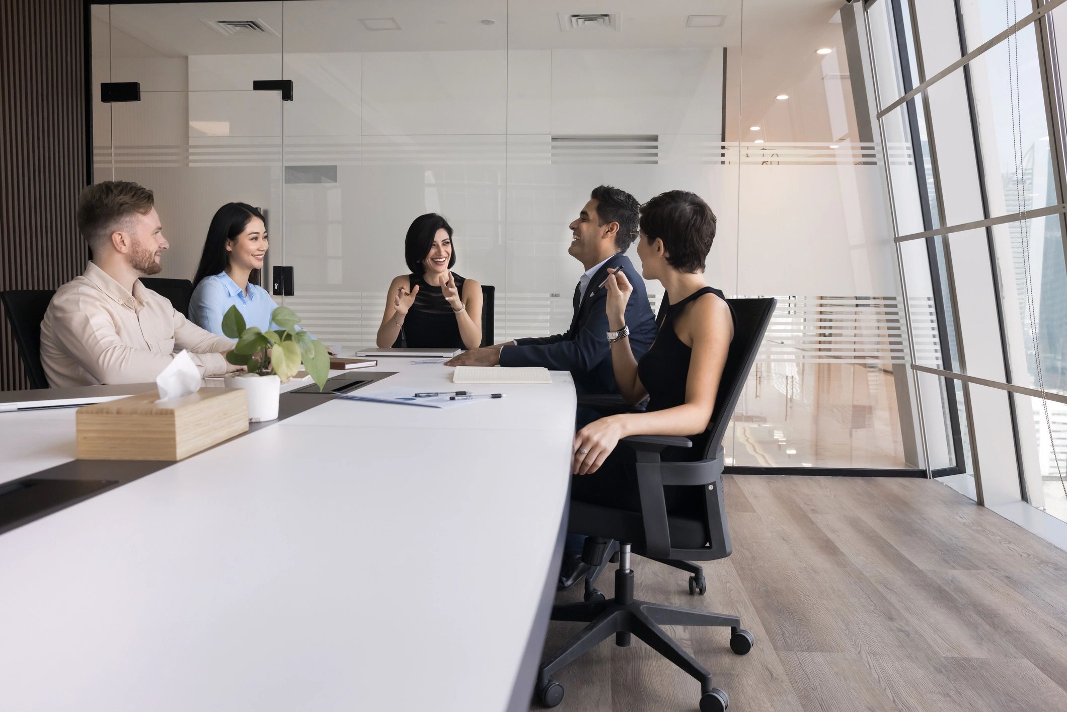 Consulting team meeting with clients in a collaboration room