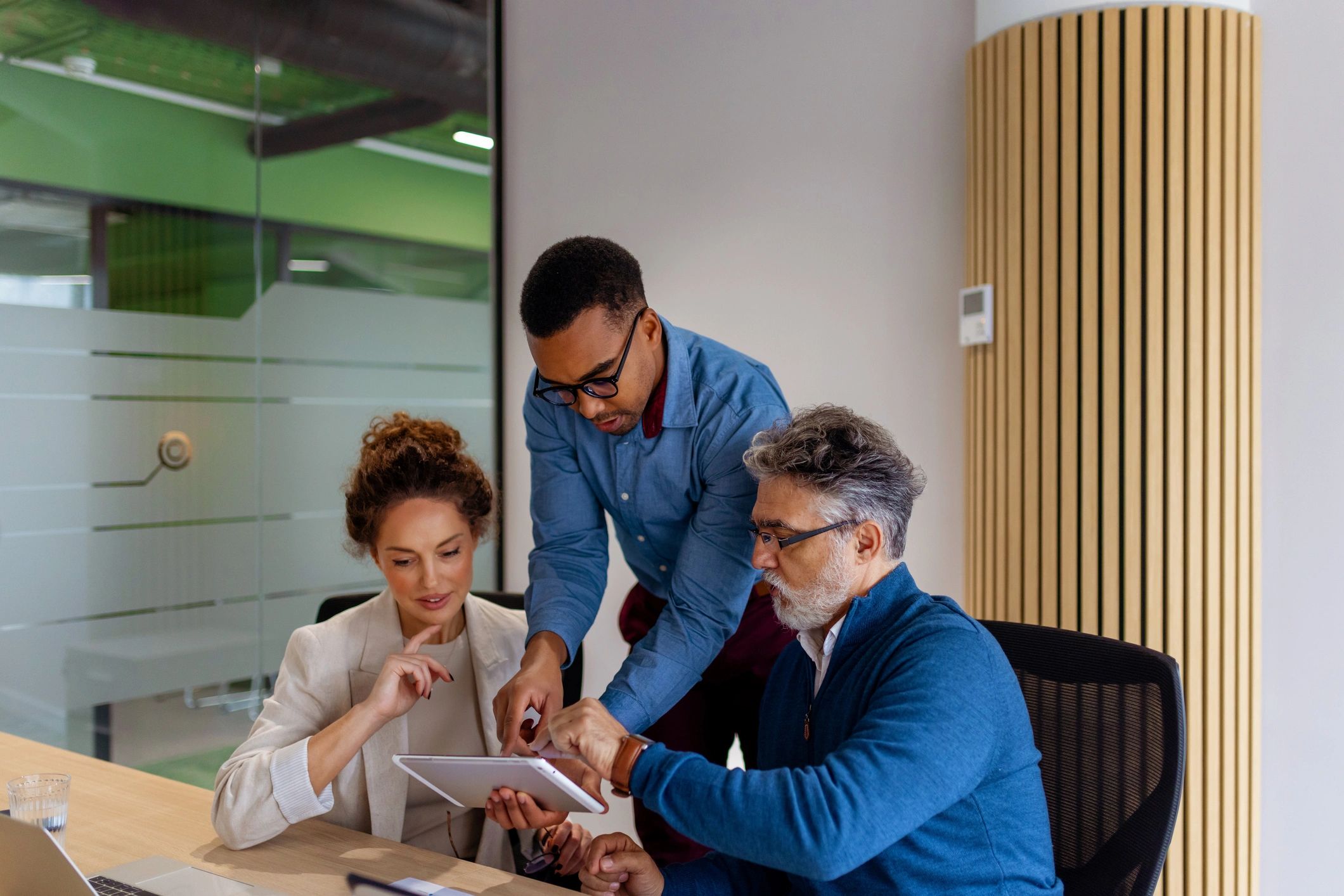 Professionals reviewing project details on a tablet